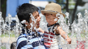 Father and Son Enjoy Fountain